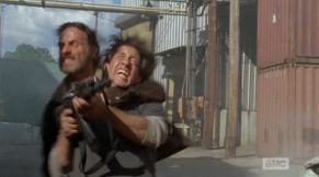 After watching the wave of shooters cross his threshold, Rick jumps out and nabs the last shooter around the neck...