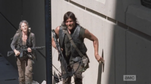 Daryl and Carol keep close to the sides of the buildings, running quietly through the streets of Atlanta.  Hug the shadows, hug the shadows, Daryl and Carol!