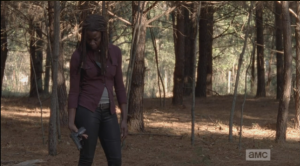 Michonne then looks down at the gun she is holding...she seems to be thinking about what the gun represents: the Alexandria way, and her new position as constable. Is their 